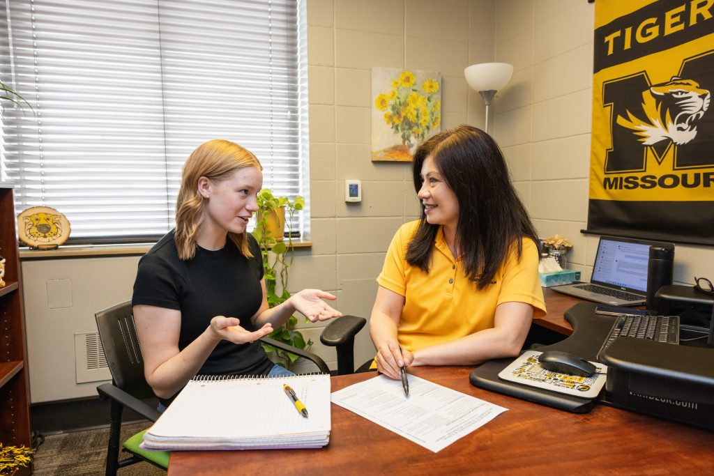 Student and academic advisor talking. 
